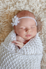 Fototapeta na wymiar Amazing newborn baby sleeping beauty enjoying first days in her his life in luxury tender clothes and blankets made by couturier