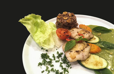 One of the Authentic delicious Healthy Thai Food is fried  fishes and herb green curry with brown rice and fresh raw vegetable.