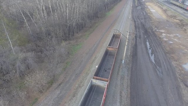 Aerial view UHD 4K of freight train with wagons and standing train with coal
