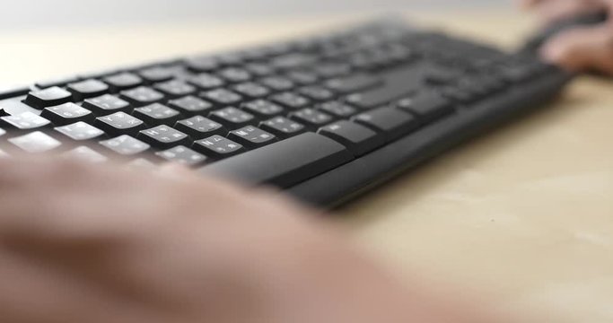 Hacker close up typing on keyboard
