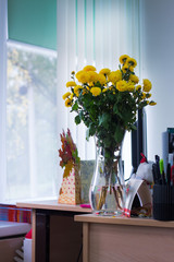 Beautiful flowers in vase with light from window .