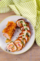Сhicken breasts with cheese and bacon. Crispy, creamy chicken wraps. View from above, top studio shot, vertical