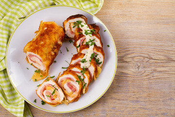 Сhicken breasts with cheese and bacon. Crispy, creamy chicken wraps. View from above, top studio shot, horizontal