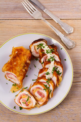 Сhicken breasts with cheese and bacon. Crispy, creamy chicken wraps. View from above, top studio shot, vertical