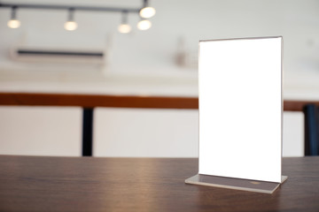 Mock up Menu frame standing on wood table in Bar restaurant cafe. space for text.