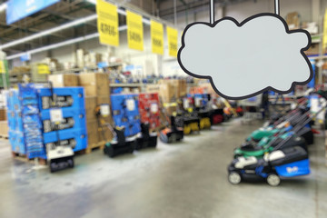 Shop of garden machinery and equipment. Lawn mowers. Defocused image. Place for your text or ad.