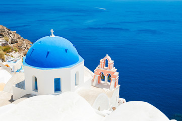 White church with blue domes on Santorini island, Greece.