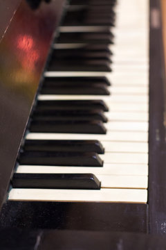 Piano keys side view with shallow depth of field .
