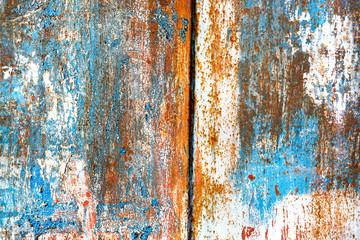 Rusty painted blue and white metal. Rough scratched structure. Background with copy space.