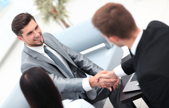 handshake business partners in the lobby of the office.