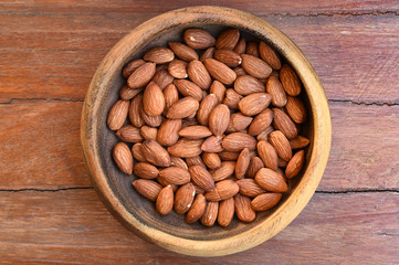 close up of almonds on wooden background
