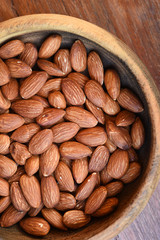 close up of almonds on wooden background