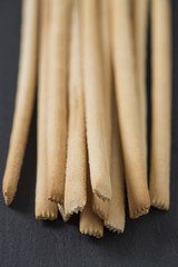 bread sticks on black stone surface