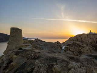 Fototapeta premium Vista aerea del Faro della Pietra al tramonto e della torre genovese, L’Ile-Rousse, Isola Rossa Corsica, Corsica, Francia 
