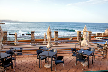 Terrace of a restaurant with sun shades on a beautiful beach