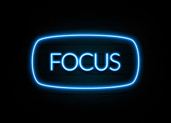 Focus  - colorful Neon Sign on brickwall