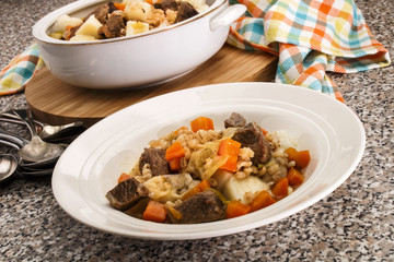 served irish beef and barley stew in a deep plate