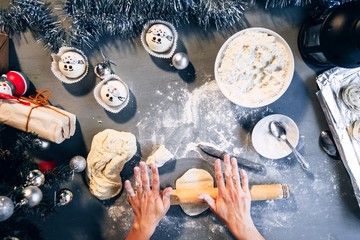 Girl hands knead the dough for baking for the Christmas table