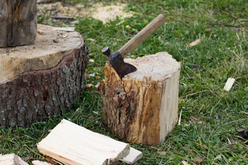 Close up piture of chopping firewood, country photo with wood and axe 