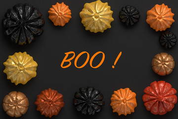 3d rendering of black, orange and gold shiny Halloween pumpkins with the word Boo in the center