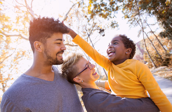 Happy young mixed race couple spending time with their daughter