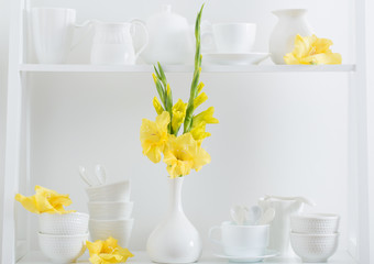 white dishvare with flowers on wooden shelf