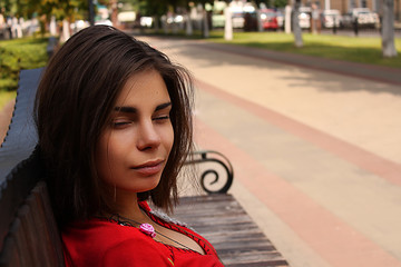 Fototapeta premium Beautiful girl on a street in the city avenue. Portrait of a brunette