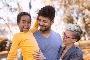 Happy young mixed race couple spending time with their daughter