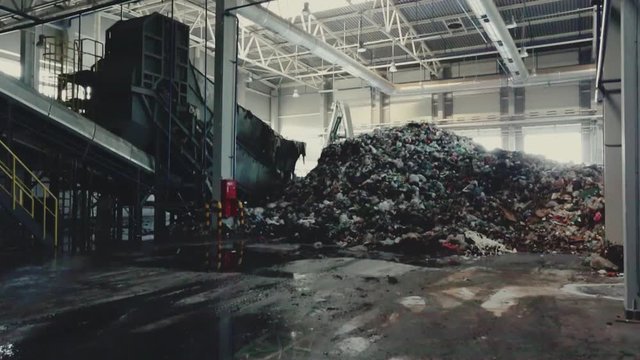 Separate garbage collection. Recycling and storage of waste for further disposal. Workers sorting material to be processed in a modern waste recycling plant