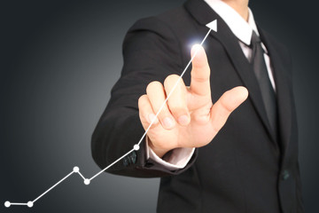 Investment concept,businessman with financial symbols coming from hand ,touch chart stock