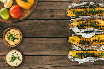 grilled corn on wooden table