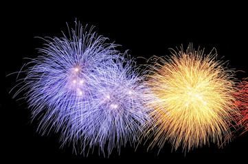 Flashes of fireworks of yellow and blue colors