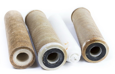 Dirty water filter cartridges on white background