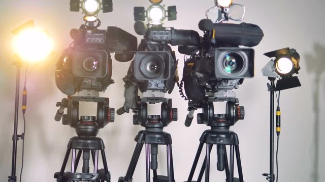 A zooming in shot of professional grade video cameras. 