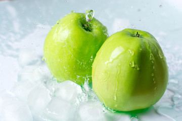 Apple with ice and water splash