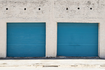 Two old blue garage doors