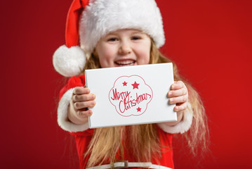 Little beautiful girl dressed as Santa Claus gifts dealer.
