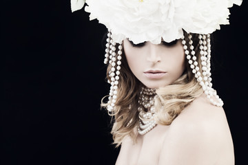 Gorgeous Woman with Pearls and White Flowers on Black Background