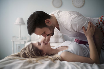 Fototapeta na wymiar Beautiful couple being romantic and passionate in bed