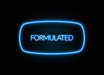 Formulated  - colorful Neon Sign on brickwall