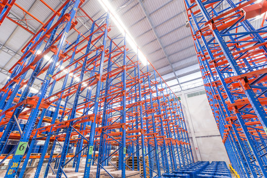logistic, storage, shipment, industry and manufacturing concept - storing at warehouse shelves