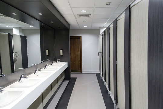 Public bathroom with sinks, mirrors and cubicles