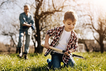 Enthusiastic kid going to dig soft soil