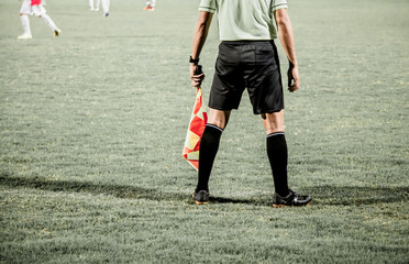 Motion blur Assistant referee or linesman are moving along the sideline during a soccer match or...