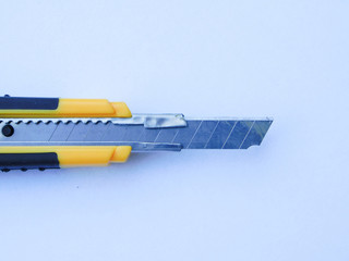 CUTTER ON A WHITE PAPER SHEET