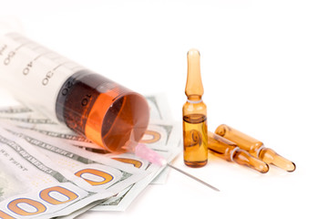 Medical ampules with syringe and dollar banknote on white background 