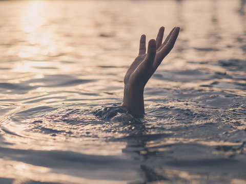 Hand Of Drowning Man Needing Help. Failure And Rescue Concept.