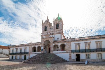 Fototapeta na wymiar The view of Nossa Senhora da Nazare Church on the central square of small town Nazare. Portugal