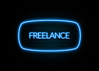 Freelance  - colorful Neon Sign on brickwall