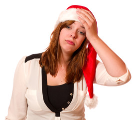 Gestresste junge Frau mit Nikolausmütze 